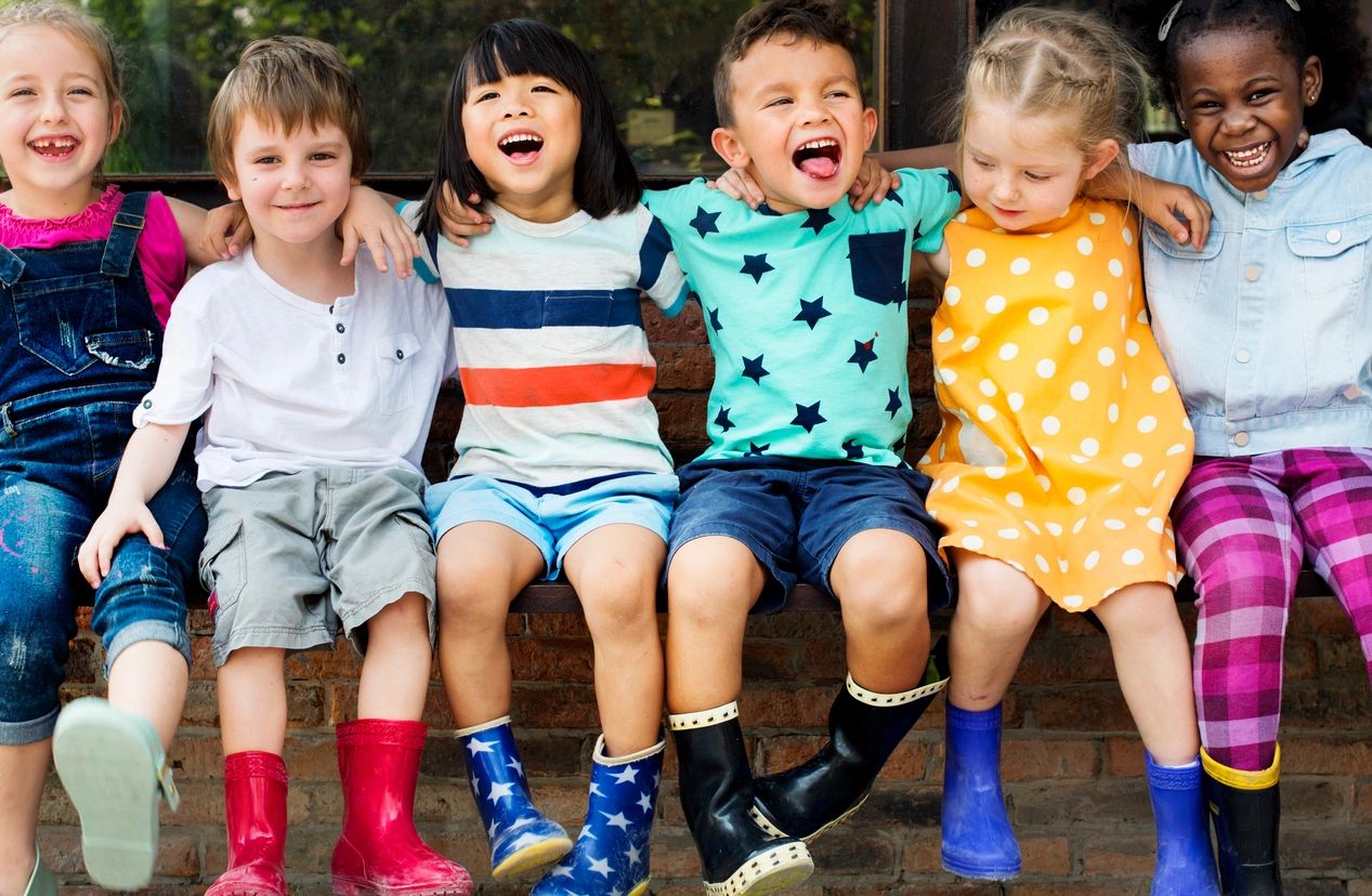 Group of kids laughing while they are outside